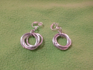 Image Description: Clip on earrings with silver color interlocking rings